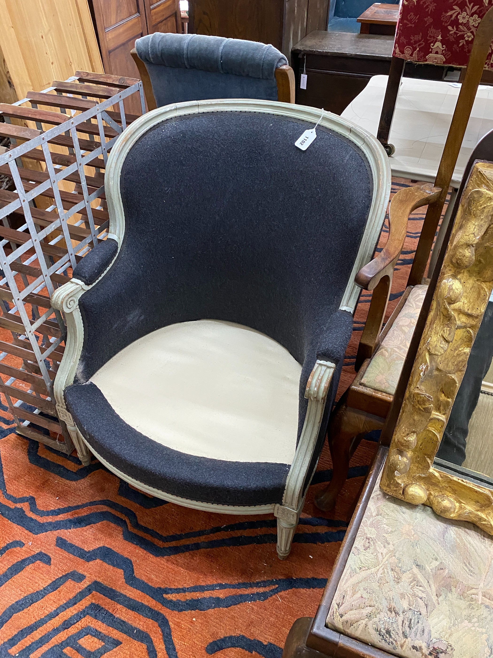 A painted French style upholstered tub frame armchair, (lacks seat cushion) width 70cm, depth 58cm, height 87cm